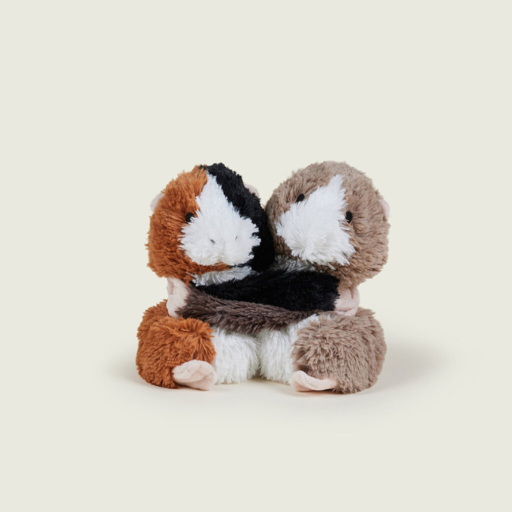 A stuffed animal holding another animalDescription automatically generated